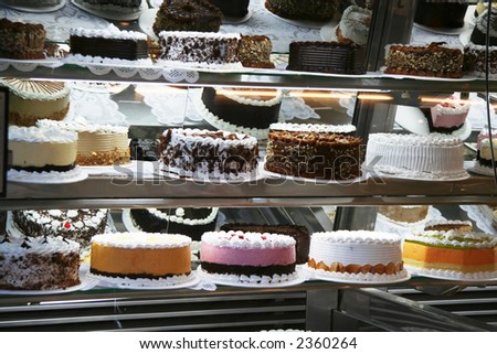 Many Cakes with cherries and chocolate in cafe