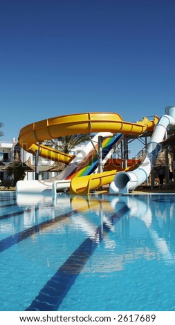 Colorful aquapark constructions in swimming-pool