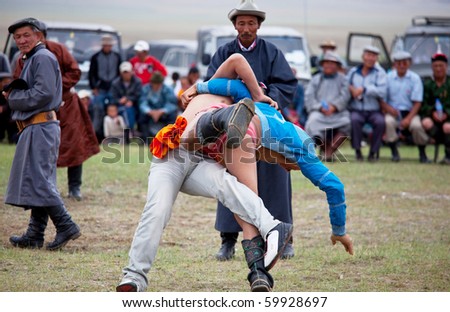MOON SUM, MONGOLIA - JULY 25: traditional Mongolian fighting festival on July 25, 2010 in Moon Sum, Mongolia. Annual holiday in honor of town birthday.