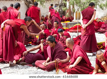 LHASA, CHINA - JUNE 3: monks debate at Sera monastery area on June 3, 2010 in Lhasa, Tibet, China. The religious debates are regular in the Sera monastery and unusual in any other Buddhist monastery.