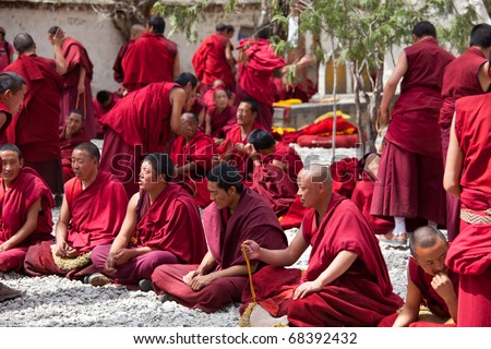 LHASA, CHINA - JUNE 3: monks debate at Sera monastery area on June 3, 2010 in Lhasa, Tibet, China. The religious debates are regular in the Sera monastery and unusual in any other Buddhist monastery.