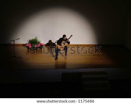 Classical guitarist performing on stage