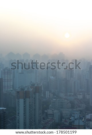 Shanghai Dawn in the City.Daybreaks in Shanghai. Apartment blocks and flats.Blue buildings, orange sunlight, smoggy atmosphere give beautiful colour to the urban skyline in the Huangpu district.