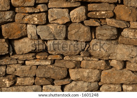 Dry Stone Wall Background Texture Digitally mixed orange cast.