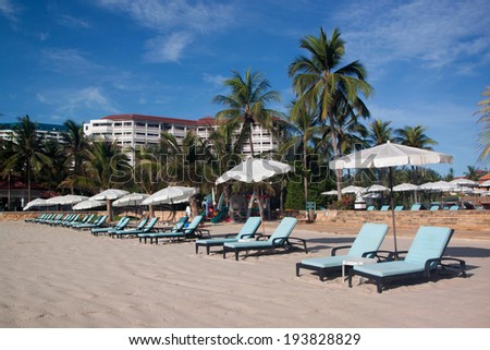 Beach chairs and white umbrella on sand beach,holidays,resort,summer