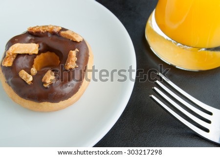 Chocolate Donuts on a plate and orange juice