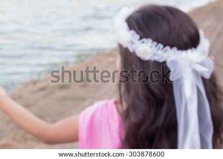 Blurred diadem of flowers on head  ,use as background