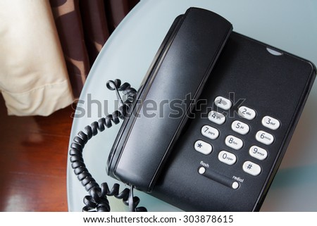 black telephone on a table