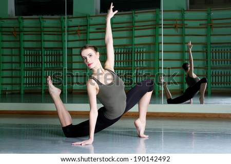 Attractive woman exercising at dance hall