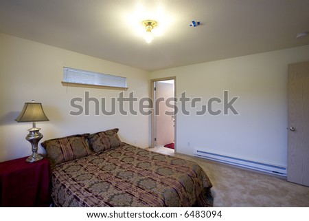 Staged bedroom with door to bathroom
