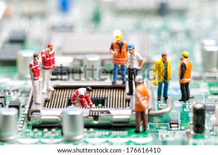 Team of engineers repairing circuit board. Computer repair concept