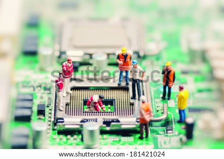 Little workers repairing motherboard. Technology concept