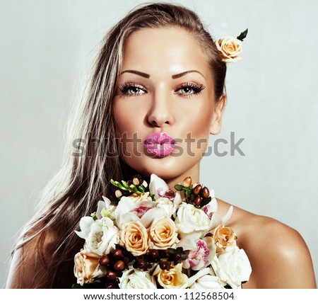 beautiful woman with long hair , holding flowers , glamour makeup