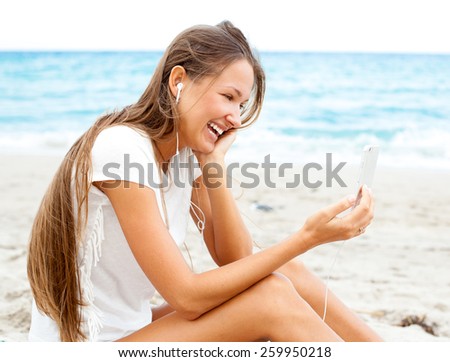beautiful girl using mobile phone device on the beach , wireless technology