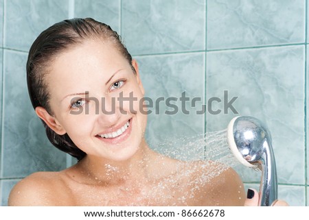 sexy and happy young beautiful woman  taking a shower