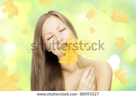 sweet woman holding autumn leaves