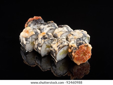 closeup of a  sushi roll , japanese food , on black background with reflection