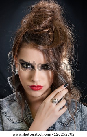 Beautiful woman with luxury luxury evening smoky make-up and curly hair