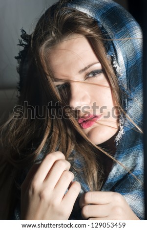 Portrait of a beautiful woman with a scarf, flying hair