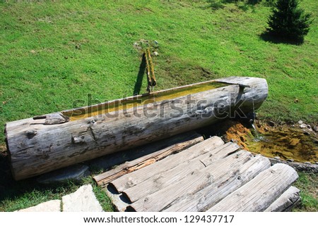 water source to fill in a wooden trough