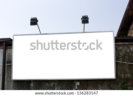 Large white blank billboard on the stone wall