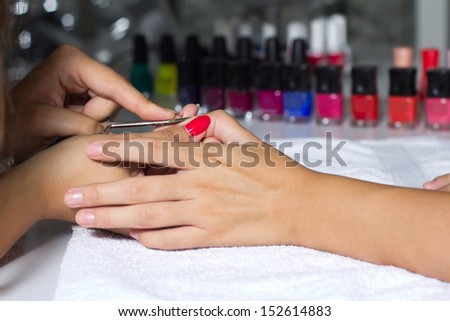 Woman in a nail salon receiving, maintenance of hygiene nails