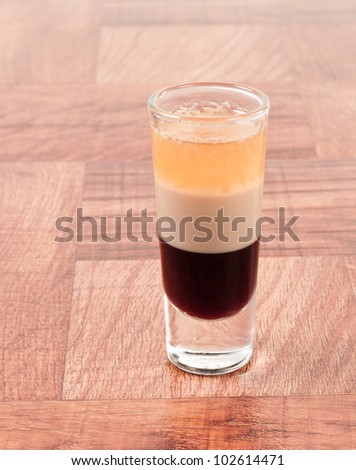 B 52 alcoholic drink layered in a tall shot glass