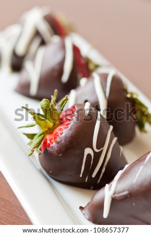 macro chocolate covered strawberries in a row, shallow depth of field focus on the second strawberry