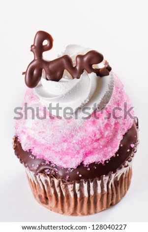 beautiful cupcake with the word love in chocolate on a white background
