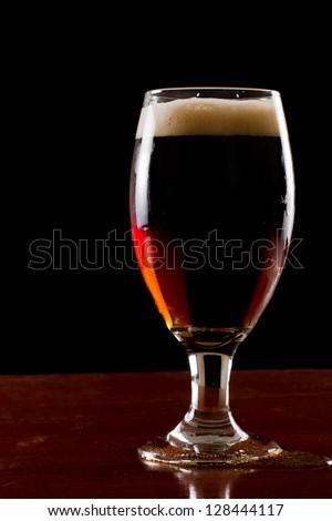 black and tan, half stout half red ale on a black background