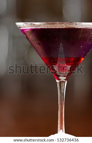 layered drink served on a bar with red on the bottom and blue on top