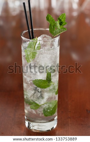 traditional mojito cocktail with fresh mint  served on a busy bar top
