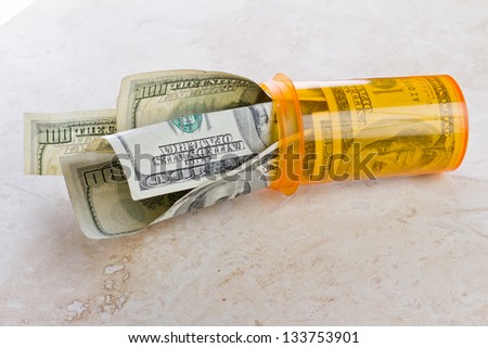 empty medicine vile with american cash representing the cost of free health care