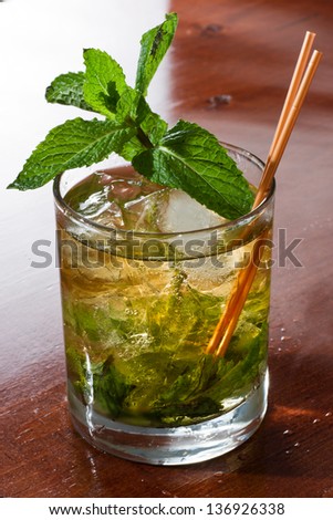 close up of a mint julep served on the rocks and garnished with fresh green mint on top, kentucky derby drink