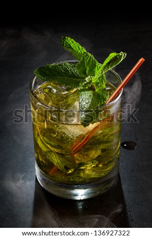 close up of a mint julep served on the rocks and garnished with fresh green mint on top, kentucky derby drink