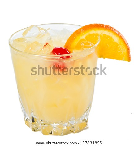 traditional whiskey sour cocktail served on the rocks garnished wiht a red cherry and an orange slice
