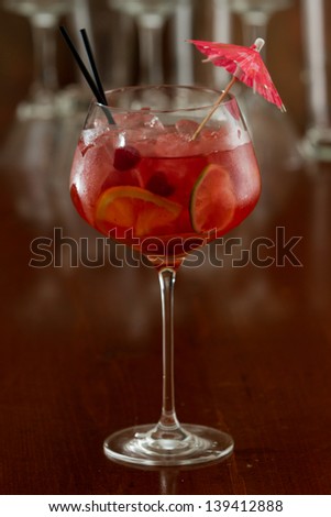red sangria served in a wine glass with fresh organic fruit