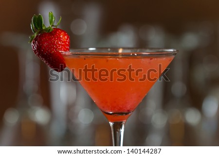 fresh muddled strawberry martini served on a out of focus bar
