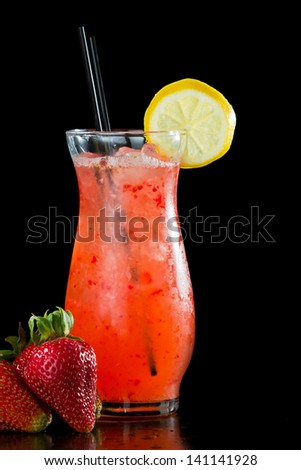 strawberry lemonade isolated on a black background garnished with a lemon wheel