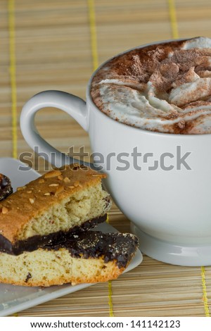 mug of hot chocolate served with chocolate dipped biscotti