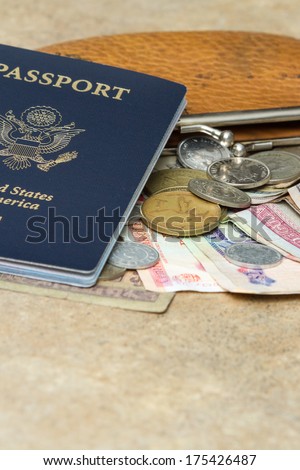 travel documents and different international currencies on a counter top