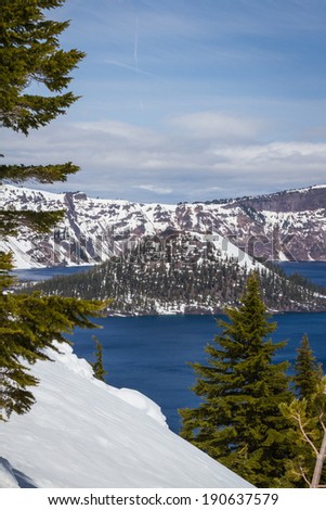 Wizard Island in Crater Lake national park in Oregon early spring with some snow left from winter