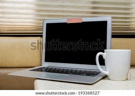 close up of a band aid on a web cam on a laptop in a home setting