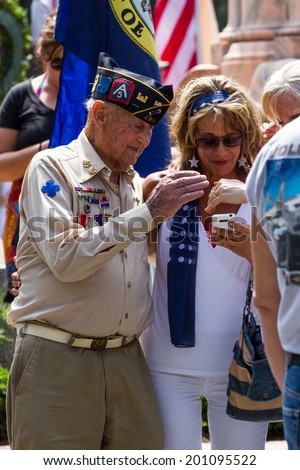 Bay Pines, Florida - May 26 : Veteran and family members looking at a smart phone after the Memorial Day parade, May 26 2014 in Bay Pines VA cemetery in Florida