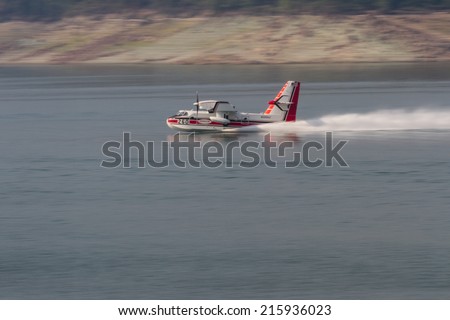 Lost Creek Lake, Oregon  - September 7 : Supperscooper plane scoping water out of Lost Creek Lake, September 7 2014 in Lost Creek Lake, Prospect Oregon