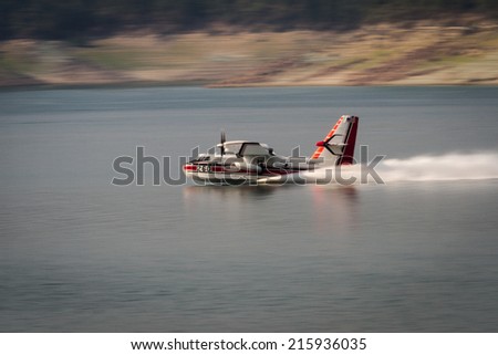 Lost Creek Lake, Oregon  - September 7 : Supperscooper plane scoping water out of Lost Creek Lake to fight the 790 fire, September 7 2014 in Lost Creek Lake, Prospect Oregon
