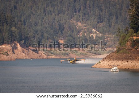 Lost Creek Lake, Oregon  - September 7 : Supperscooper plane scoping water out of Lost Creek Lake to fight the 790 fire, September 7 2014 in Lost Creek Lake, Prospect Oregon