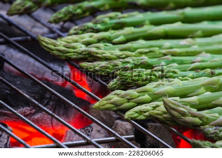 grilled asparagus on an outdoor grill with open flame