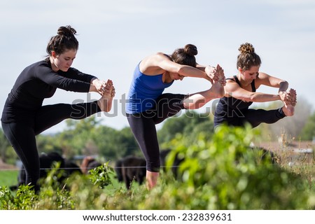 group of young people practicing in an outdoor yoga class