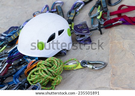 close up of technical rock climbing gear layer out on a rock